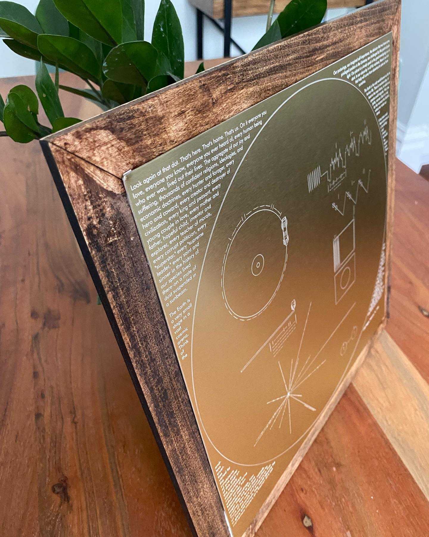 One of my best friends is a huge space nerd, so for his birthday I built him a replica of the Voyager record plaque in laser engraved gold-anodized aluminum. The frame is laser cut balsa wood with a geometric pattern, and around the record is the Pale Blue Dot speech by Carl Sagan. The back features a personal note.
